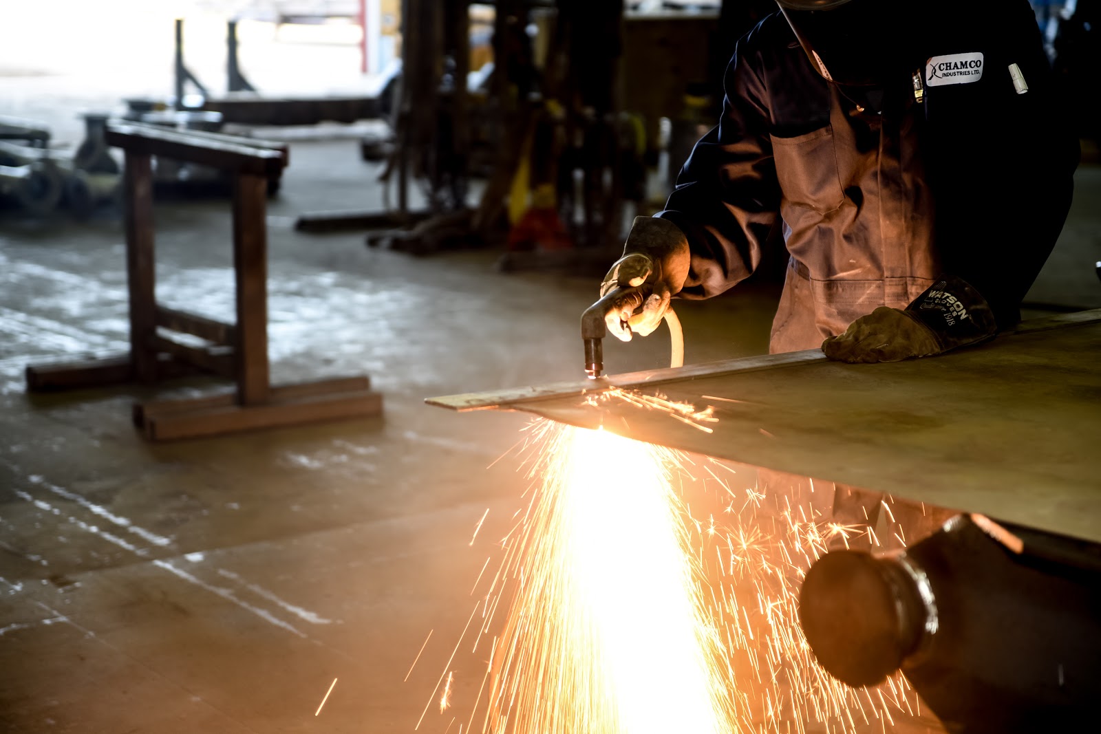 A Chamco technician cutting metal